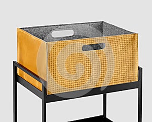 Comfortable tan suede woven storage box on metal shelving rack