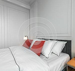 Comfortable white luxury bed with romantic red pillows of bedroom