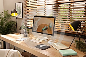 Comfortable workplace near window in room. Interior design