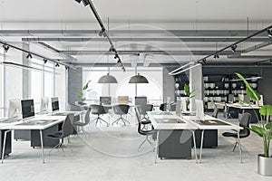 Comfortable workplaces in a open loft office interior with desks, computers, and a window. Concrete floor and dark walls.