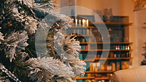 Comfortably decorated Christmas shop window, beautiful Christmas tree close-up