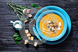 Comforting autumn pumpkin soup in a blue plate