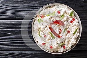 Comforting Curd Rice is a popular dish from South India with yogurt and then tempered with spices closeup in a plate. horizontal