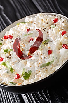 Comforting Curd Rice is a popular dish from South India with yogurt and then tempered with spices closeup in a plate. Vertical
