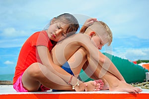 Comforting a friend. Young girl hugs her adorable boy