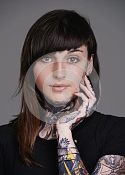 Comfotable in my own skin. A cropped studio portrait of a beautiful tattooed young woman.