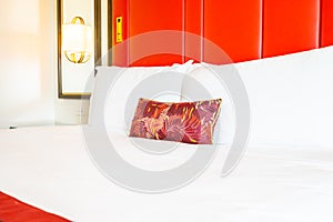 Comfotable pillow on bed with light lamp decoration