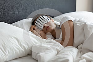 Comfy sleeping mask helping young woman enjoy good healthy sleep