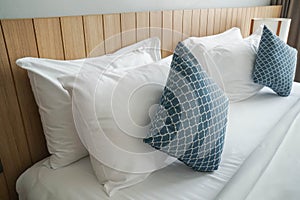 comfy white pillows on double bed mattress in luxury hotel bedroom for honeymoon