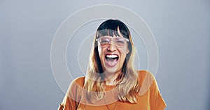 Comic, face and woman laughing in a studio for funny or silly joke in conversation with happiness. Smile, portrait and