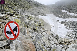 Comic warning sign to warn of the danger of wearing high heels on a stone mountain path in the High Tatras