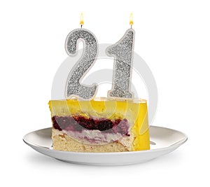Coming of age party - 21st birthday. Delicious cake with number shaped candles on table against white background