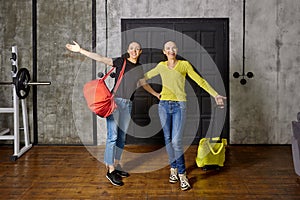 Coming home after vacation, two slender mature women greet their