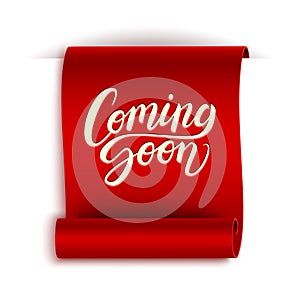 Coming soon calligraphic lettering text composition on realistic red ribbon isolated on white, vector illustration