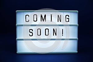 Coming Soon letterboard text on LED Lightbox on blue background
