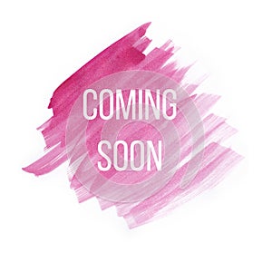 Coming soon on pink watercolor brush strokes on white background