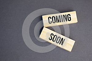 Coming Soon words on wooden blocks on yellow background. Business ethics concept