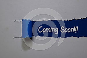 Coming Soon! write on blue and white torn paper