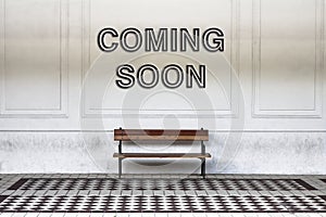 Coming soon written on a wall above a wooden bench - concept image