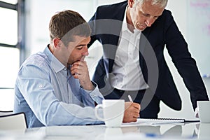 Coming up with a plan of action. Shot of two businesspeople having a discussion in a corporate office.