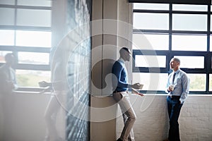 Coming up with a solid plan of action. two businessmen having a discussion in an office.