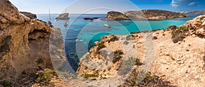 Comino, Malta - The beautiful Blue Lagoon with turquoise clear sea water, yachts and snorkeling tourists