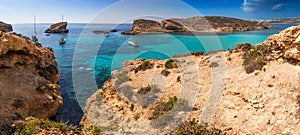 Comino, Malta - The beautiful Blue Lagoon with turquoise clear sea water, yachts and snorkeling tourists