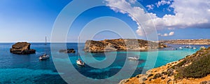 Comino, Malta - Panoramic skyline view of the famous and beautiful Blue Lagoon on the island of Comino with sailboats