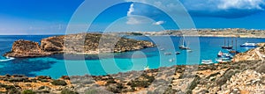 Comino, Malta - Panoramic skyline view of the famous and beautiful Blue Lagoon on the island of Comino with sailboats