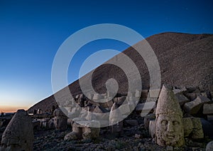 Commagene statues on the summit of Mount Nemrut during sunset with stars in the sky, Adiyaman, Turkey