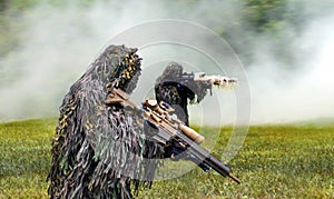 Commando dressed in ghillie camouflage during  combat warfare