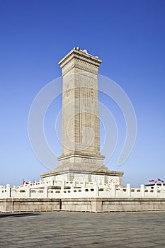 Commemoration monument Tiananmen Square Beijing against a blue sky