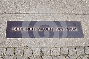 Commemorative plaque at the site where the Berlin Wall once divided the city