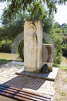 Commemorative slab and the Lom river at Rock Monastery St. Dimitar Basarabovski