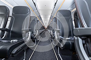 Commercial aircraft cabin with empty seats.