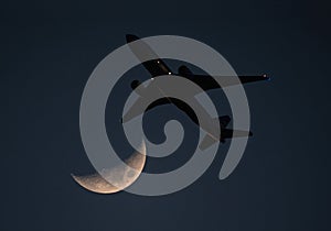 Commercial Airliner and Crescent Moon at Dusk