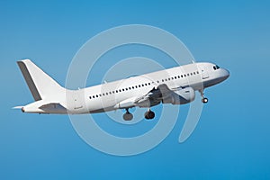 Commercial airliner flying midair after takeoff photo