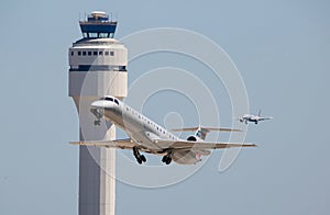 Commercial Airliners Taking Off and Landing with Control Tower