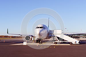 Commercial airplane with connected boarding ramp