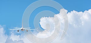 Commercial airplane flying above clouds on day light, Clear blue sky and fluffy soft white cloud with copy space