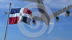 Commercial airplane flying above waving flag of the Dominican Republic. 3D rendering