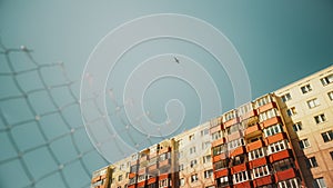 Commercial Airplane Flying Over a Suburbian Part of an Eastern European City on a Sunny Day with photo