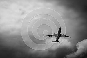 Commercial airplane on grey sky and clouds with copy space. Failed vacation. Hopeless and despair concept. Moody sky and transport