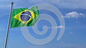 Commercial airplane landing behind waving Brazilian flag