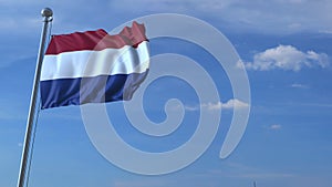 Commercial airplane landing behind waving Dutch flag