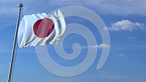 Commercial airplane landing behind waving Japanese flag