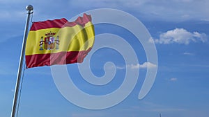 Commercial airplane landing behind waving Spanish flag