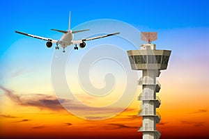 Commercial airplane take off over airport control tower