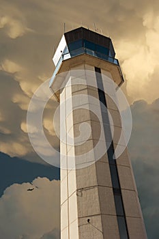 Commercial Airport Control Tower Photo Illustration From Close Up Perspective with large storm developing overhead