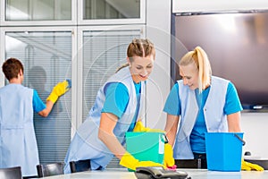 Cleaning brigade working in office